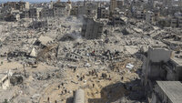Bildet viser palestinere som går gjennom ødelagte områder etter en israelsk militæroperasjon mot Shifa-sykehuset på Gazastripen.
